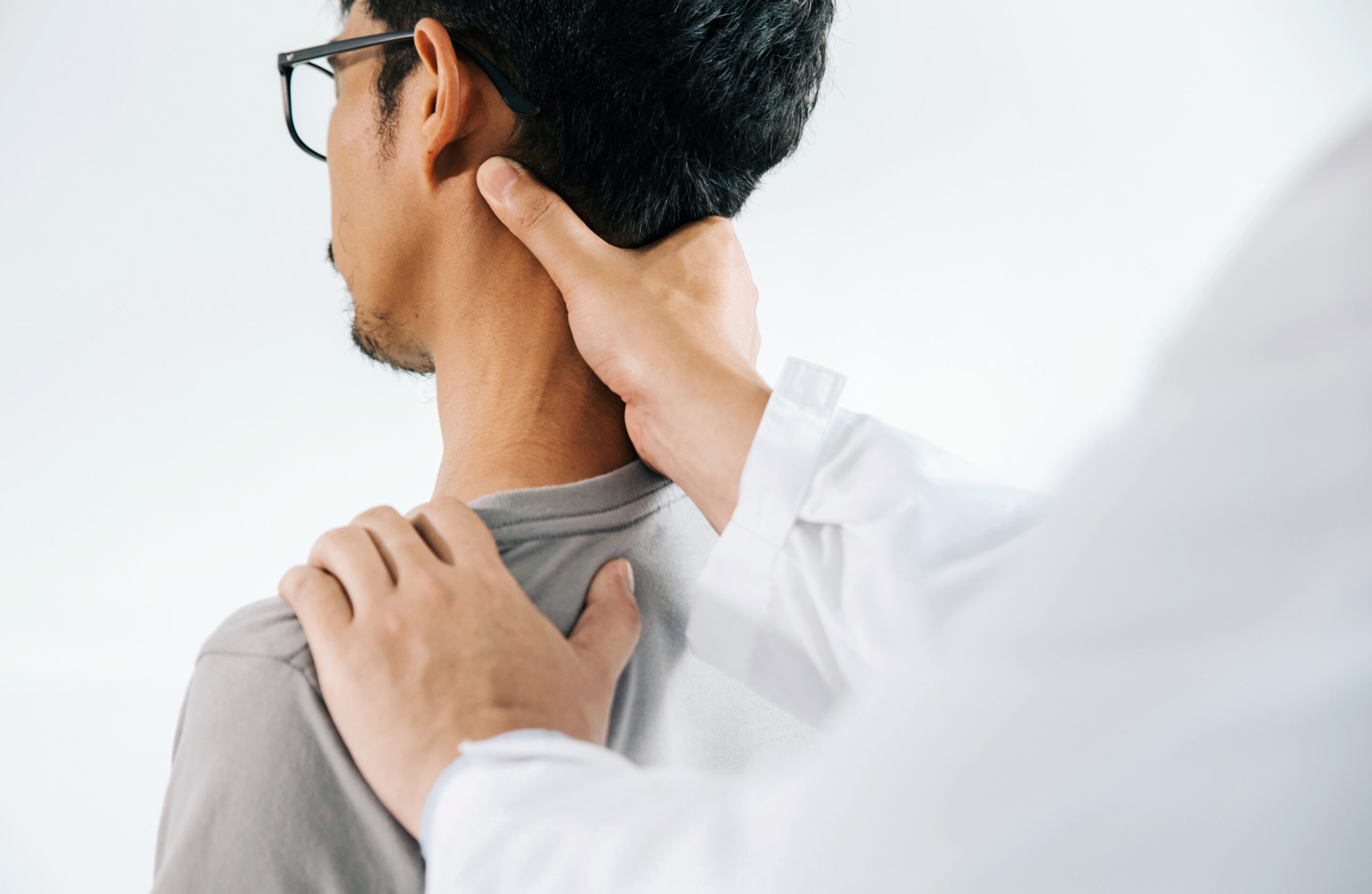 Physiotherapist doing healing treatment on man's neck,Chiropract